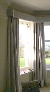 Straight pelmet with pop pom trim in bay window. Morris and Co Pure fabric