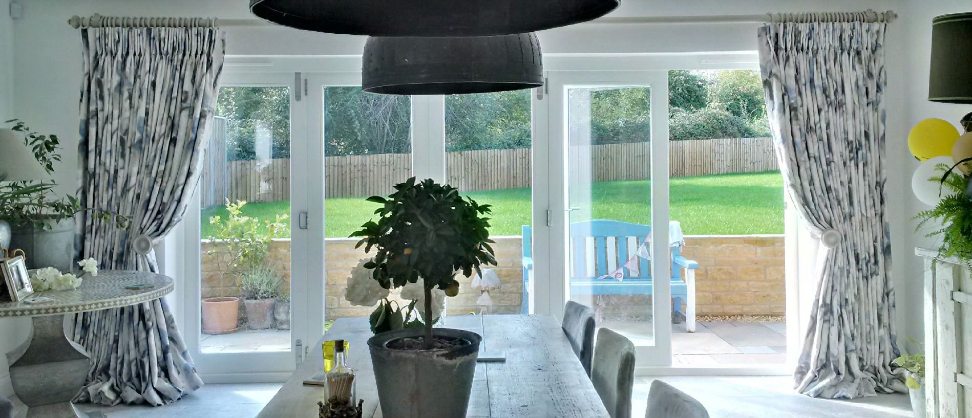 Extra wide windows with double pleat curtains in Zoffany Water Iris Ink/Charcoal, with Alison Davie Couture curtain pole and matching hold backs. Cheltenham, Gloucestershire