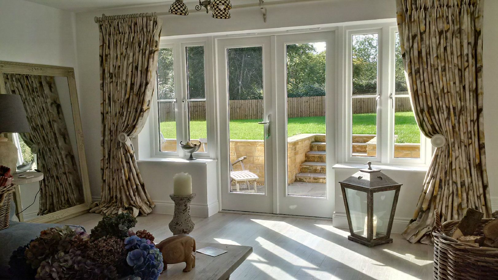 Extra wide windows with double pleat curtains in Zoffany Water Iris Gold/Charcoal, with Alison Davies Acanthus curtain pole and matching hold backs. Cheltenham, Gloucestershire.