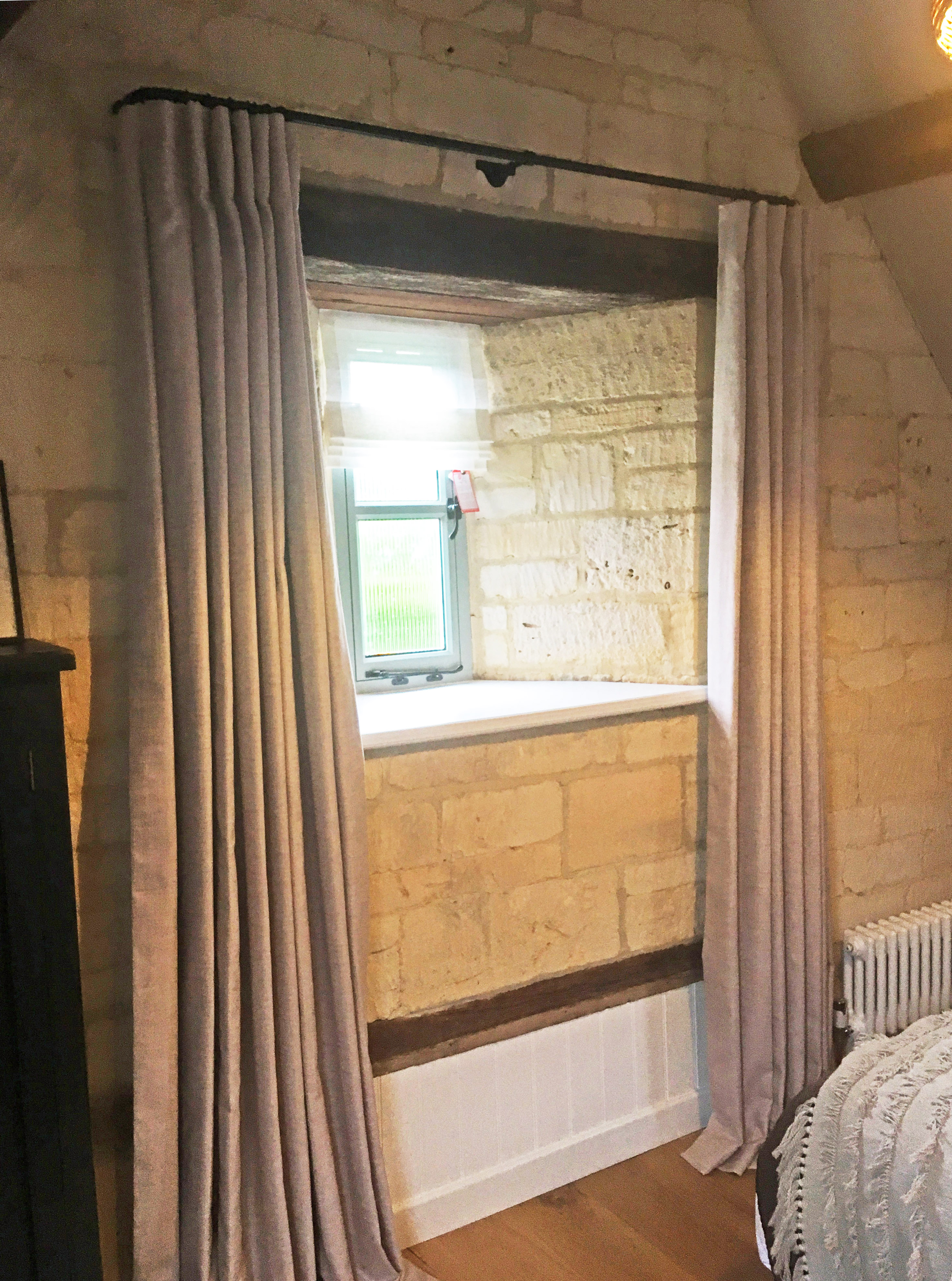 Inverted pleat linen curtains on 19mm diameter black French pole, with sheer linen roman blind. Cotswold Barn conversion near Cheltenham.