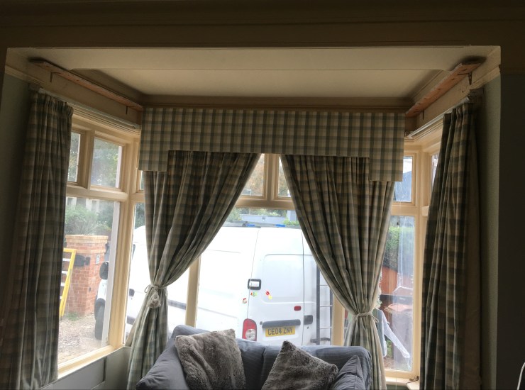 Before - traditional pelmets and separate curtain panels clog the light. Cheltenham Town House